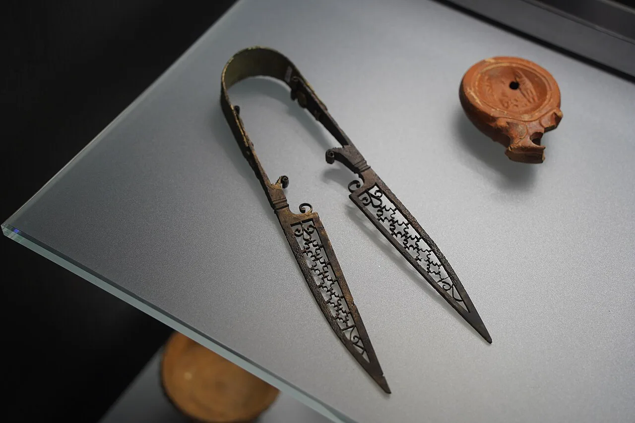 Roman iron shears and an oil lamp displayed at the Zadar Archaeological Museum