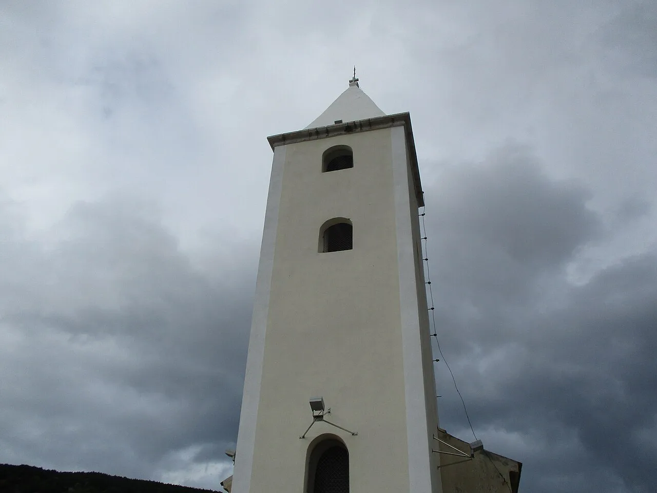 The white bell tower of a church in Baška on Krk, Kvarner