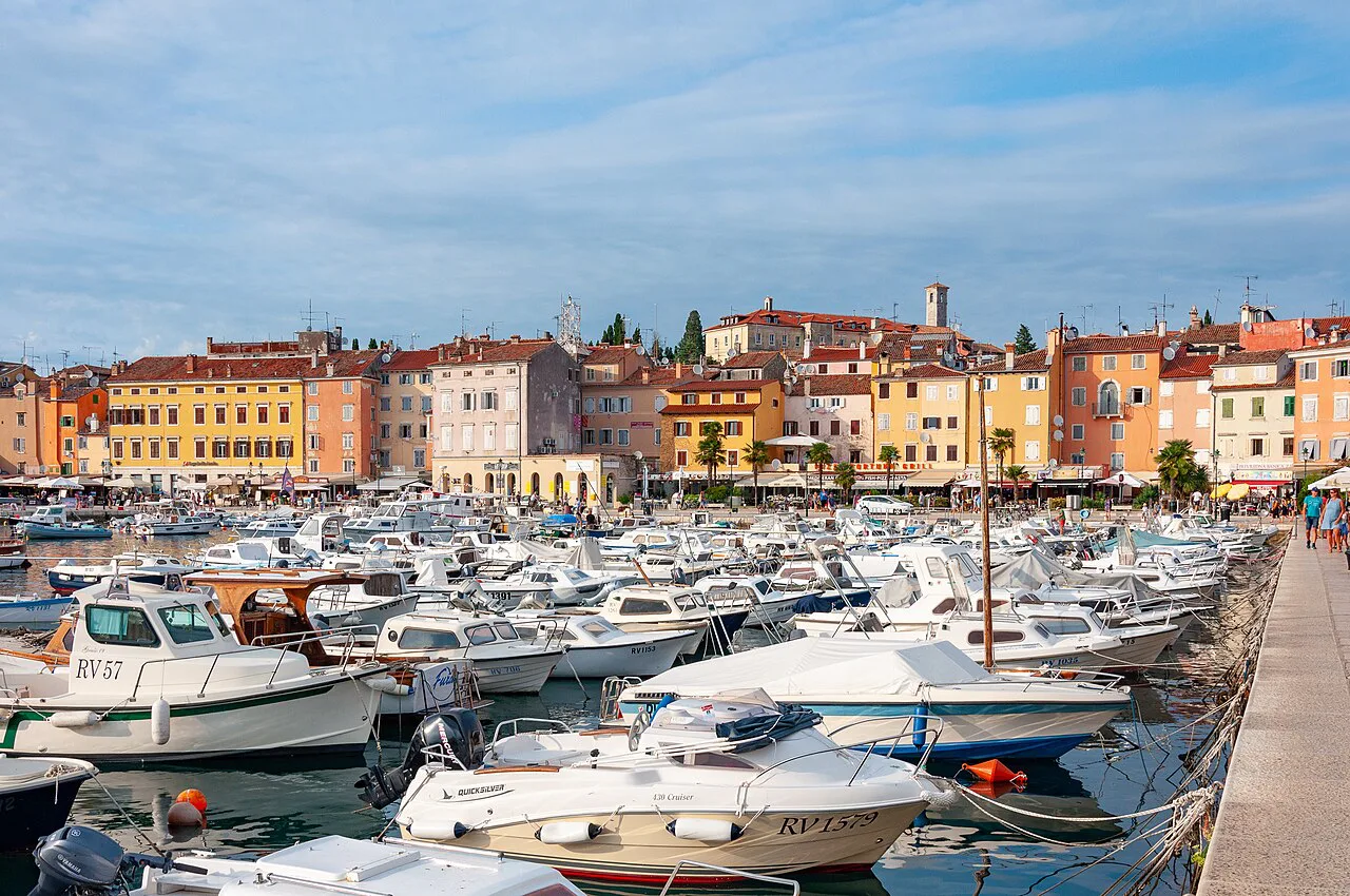 Rows of small boats moored in Rovinj harbour below the old town
