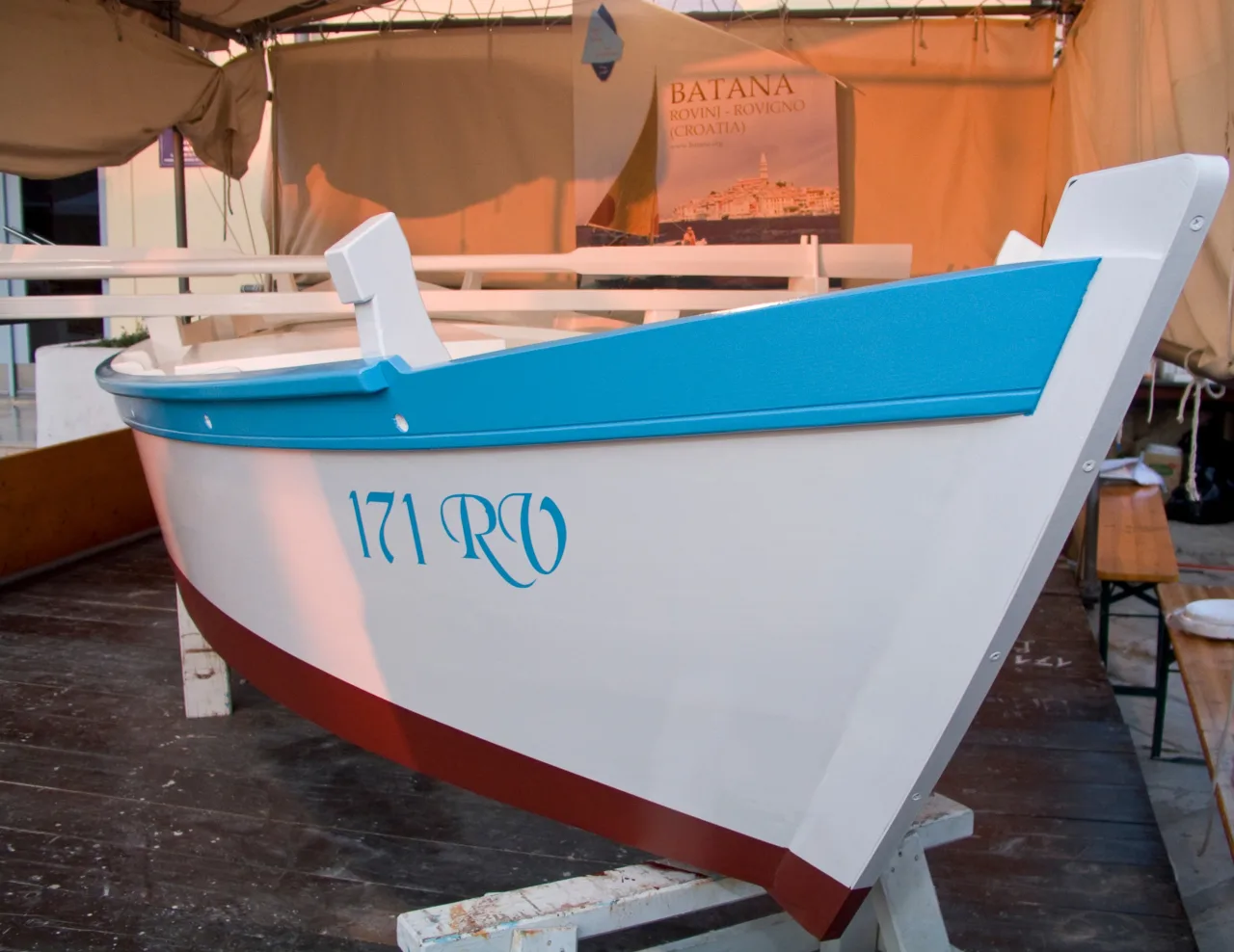 A blue and white wooden batana boat on display in Rovinj.