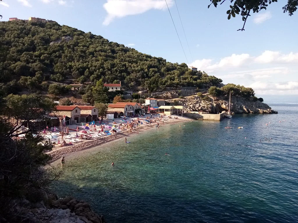 A pebble beach below wooded slopes near Beli on the island of Cres, Kvarner