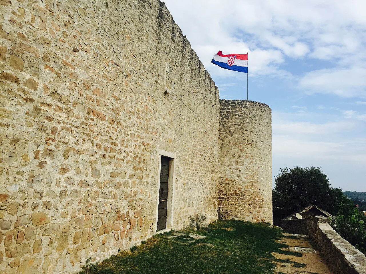 Stone walls and a round tower of the fortress in Benkovac, Dalmatia