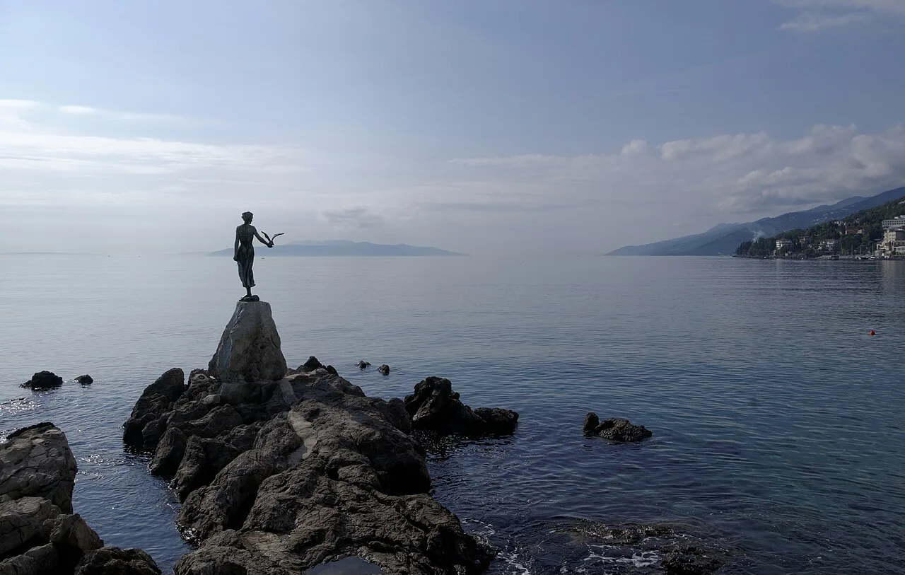 The Maiden with the Seagull statue on rocks by the sea in Opatija, Croatia