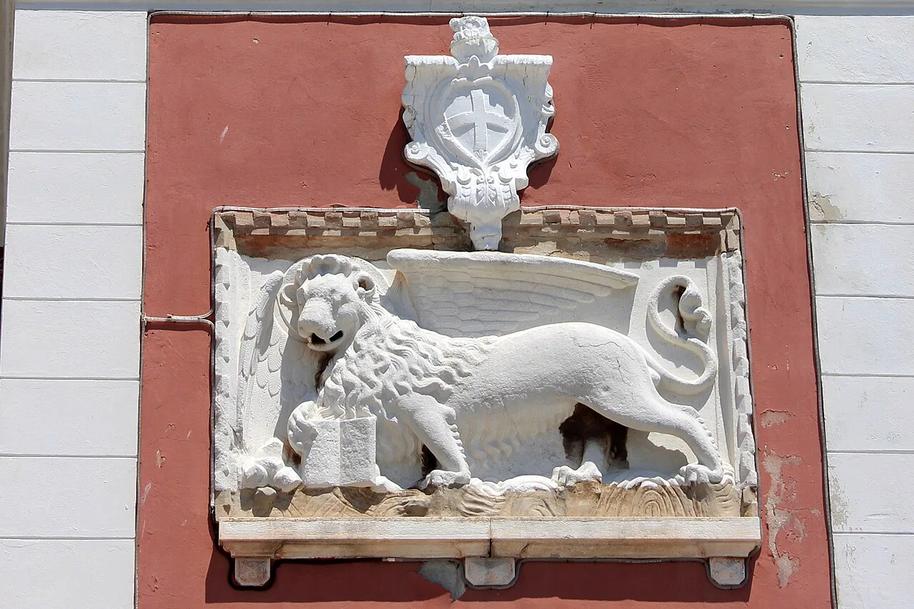A carved lion of Saint Mark relief on the clock tower in Rovinj