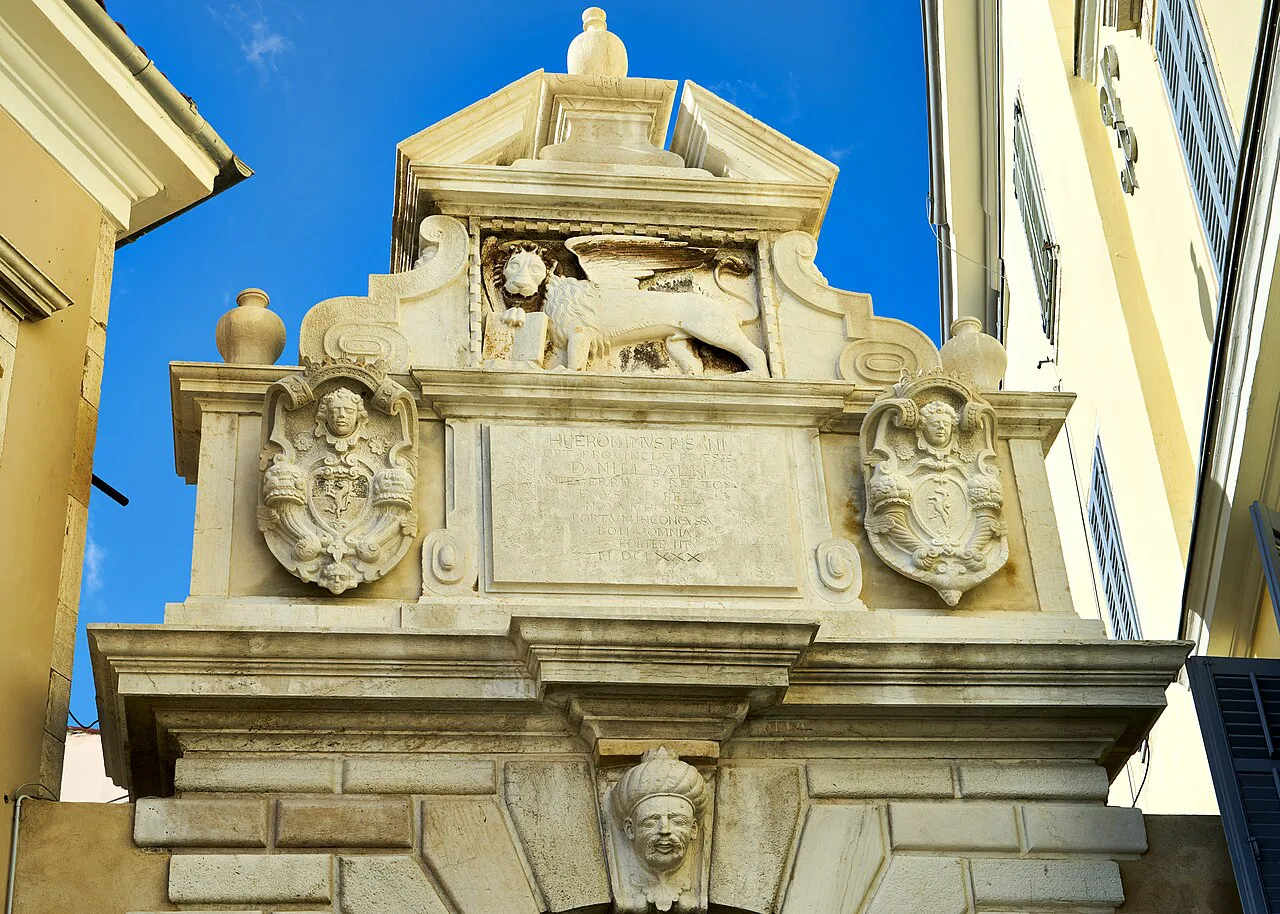 The carved top of Balbi's Arch with a Venetian lion relief in Rovinj.