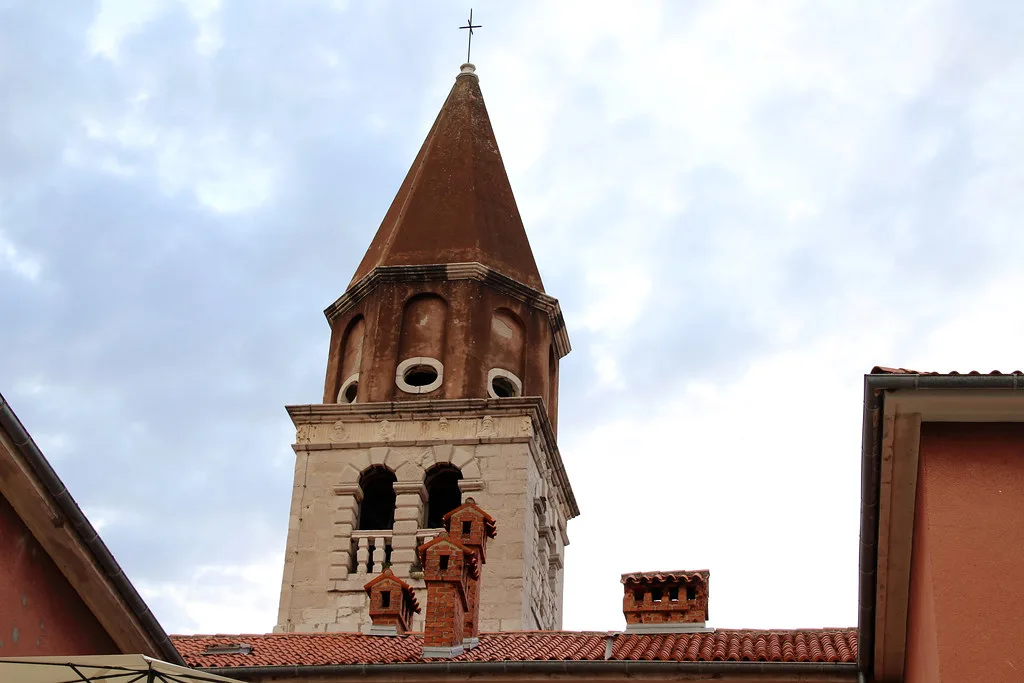 The brick bell tower of the Church of St Simeon above rooftops in Zadar.