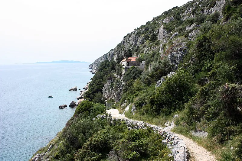 A coastal path below steep rocky cliffs on the island of Čiovo, Dalmatia