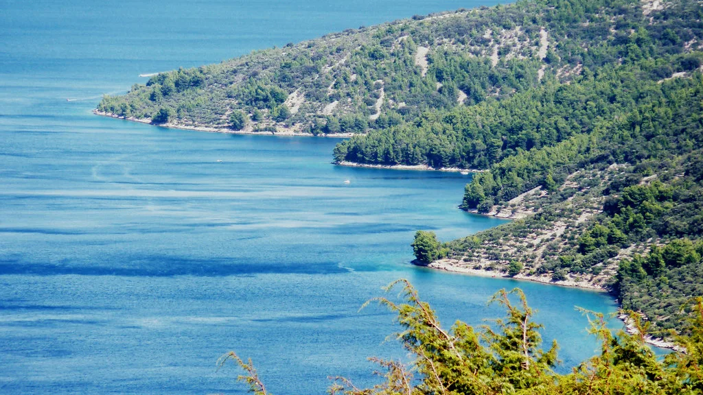 Wooded headlands and blue water in a bay on the island of Cres, Kvarner
