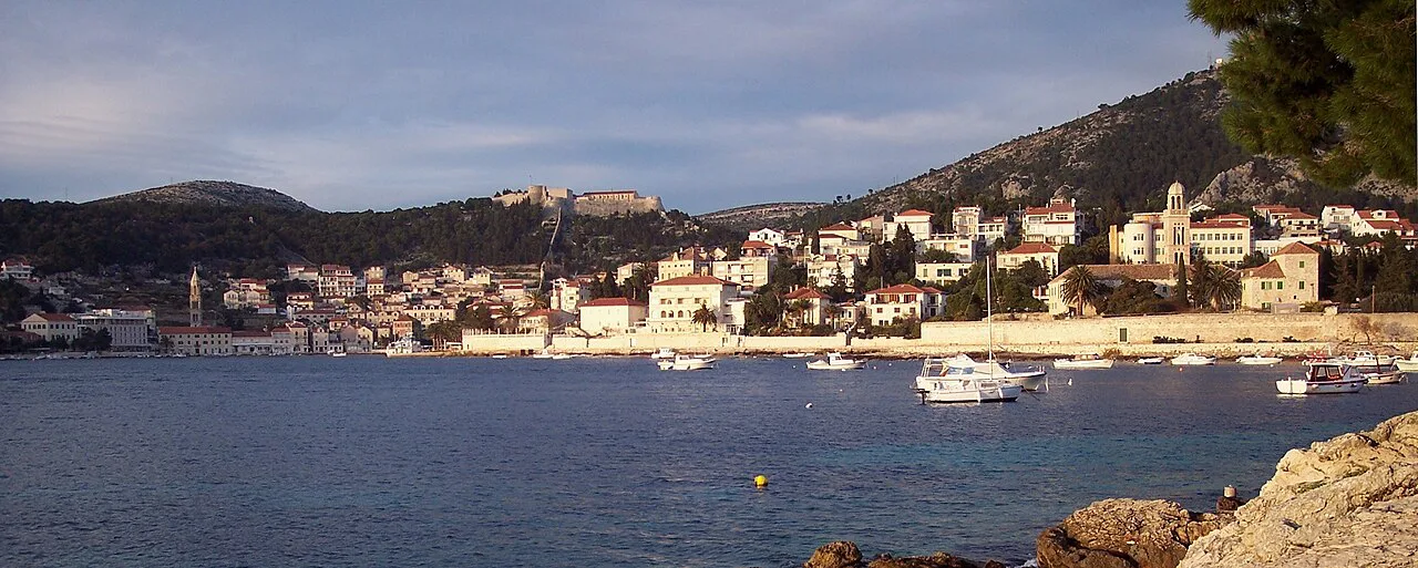 Hvar Town spread along the shore, seen from the south across the water, Croatia