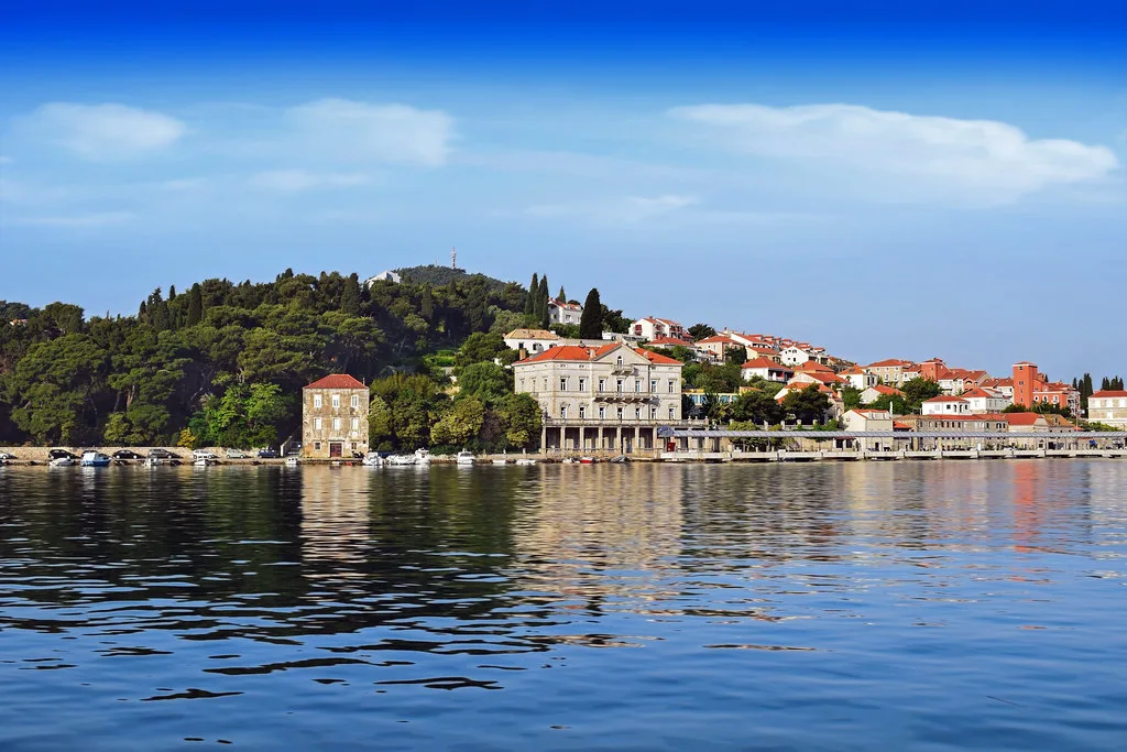 Waterfront villas below wooded hills on the Adriatic coast at Dubrovnik, Croatia