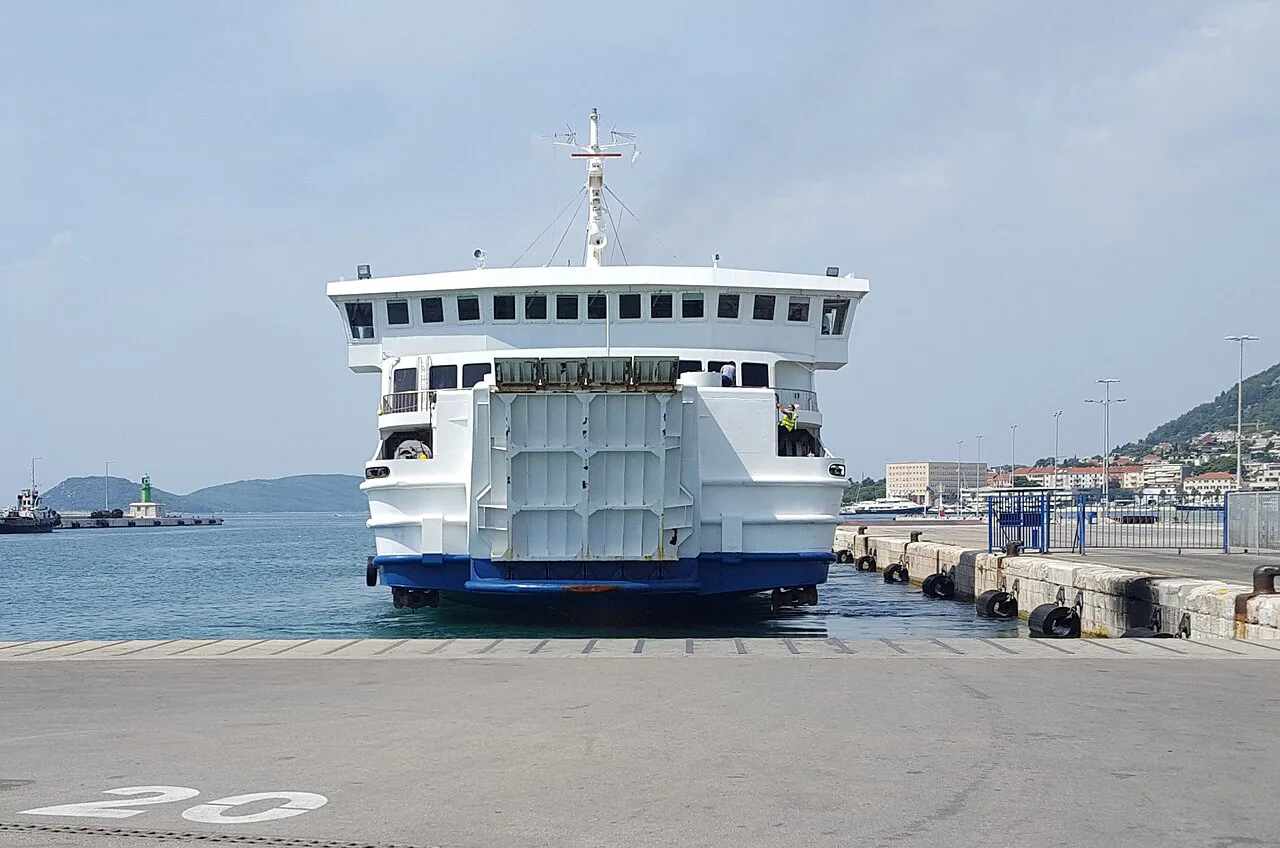 A white Jadrolinija roll-on roll-off ferry moored at a quay in Croatia