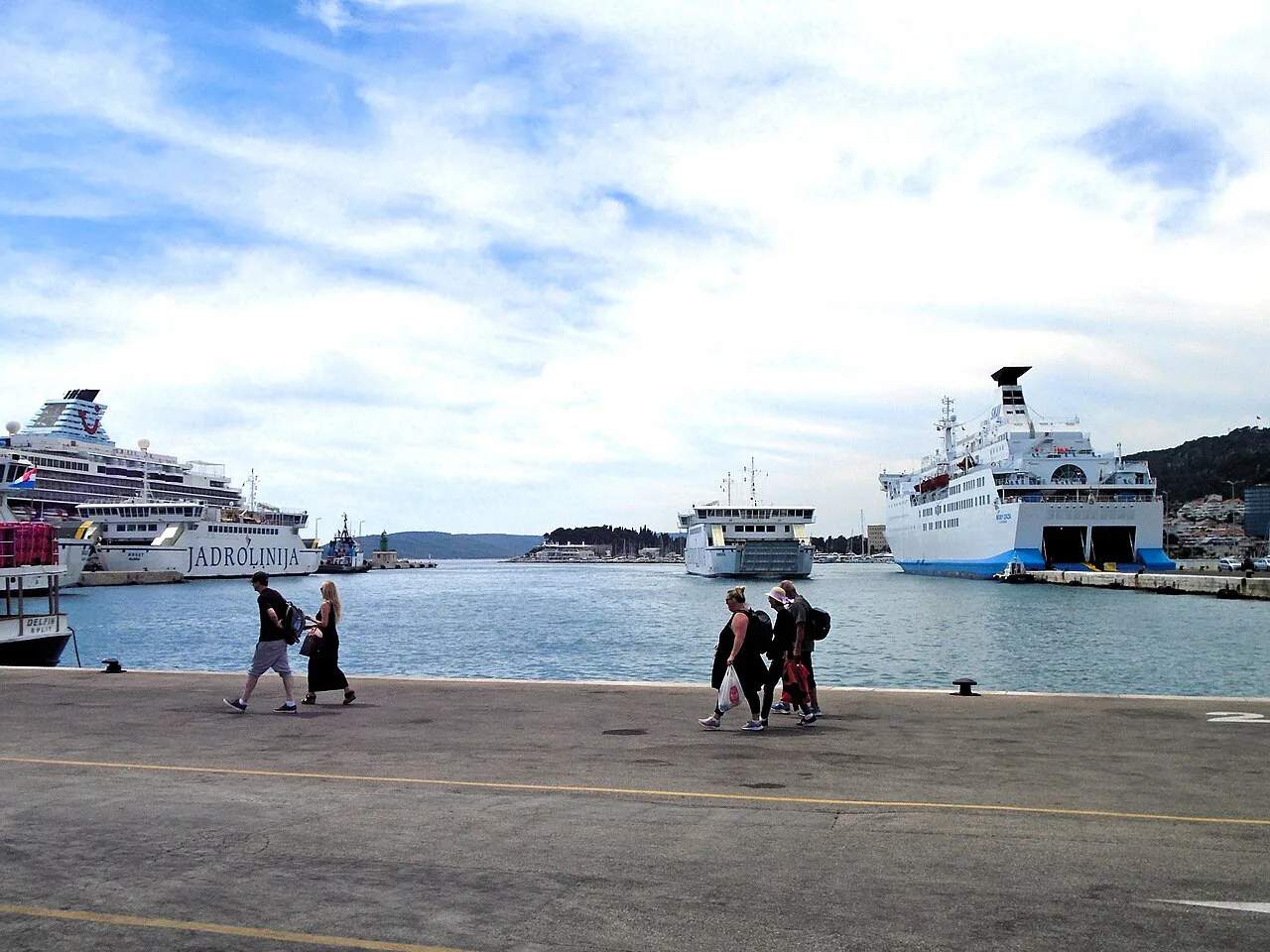 Ferries moored at the ferry terminal in Split, with passengers on the quay.