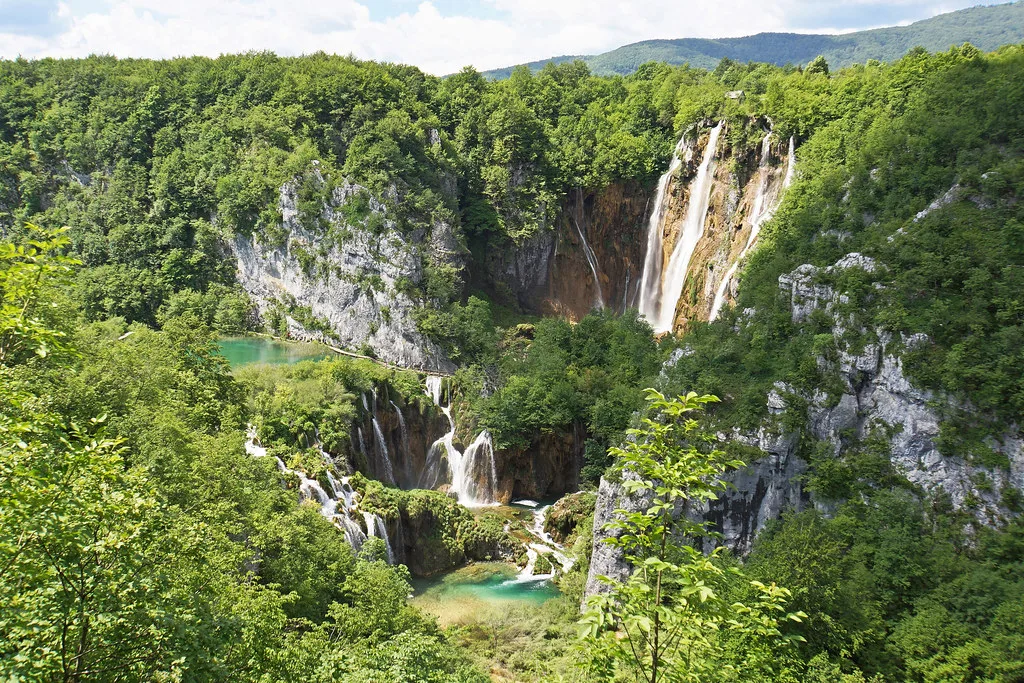 Waterfalls and forested slopes in Plitvice Lakes National Park, Croatia