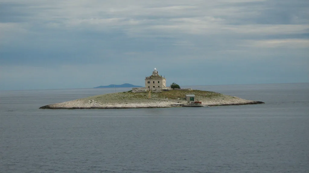A small lighthouse on a rocky islet just off the island of Hvar, Croatia