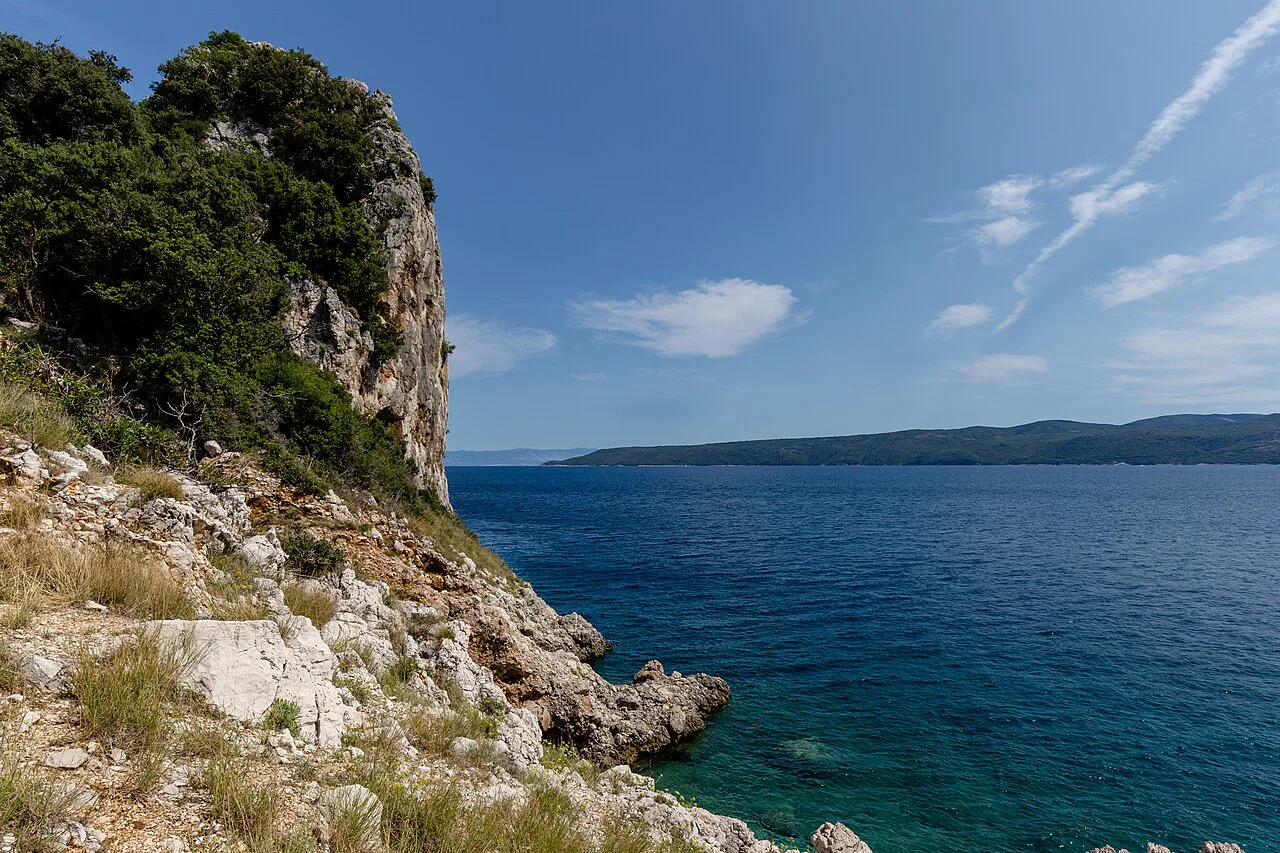 Rocky cliffs and clear blue sea along the coast north of Stupova Beach, Croatia