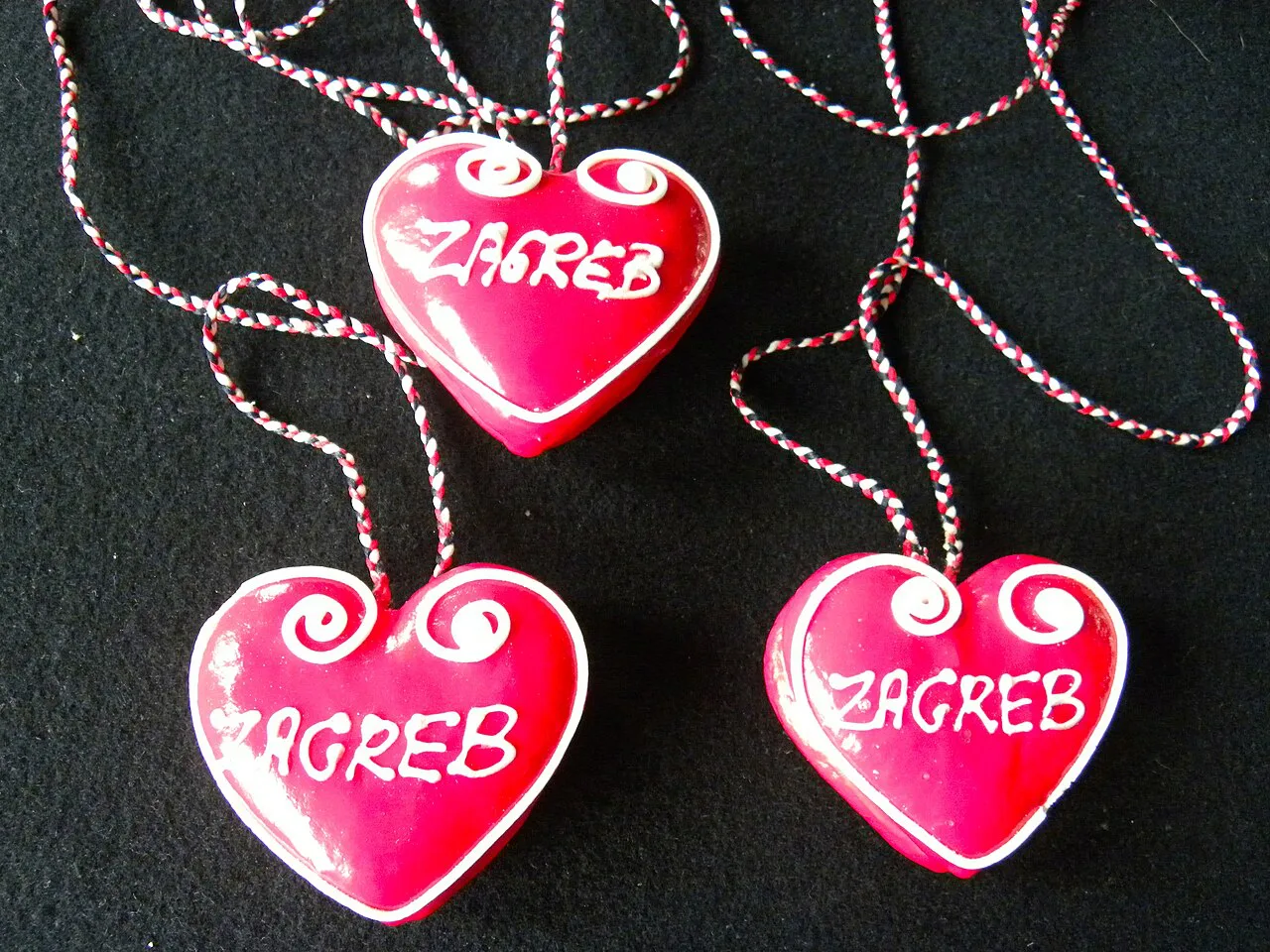 Red heart-shaped souvenirs inscribed with Zagreb on decorative cords, Croatia