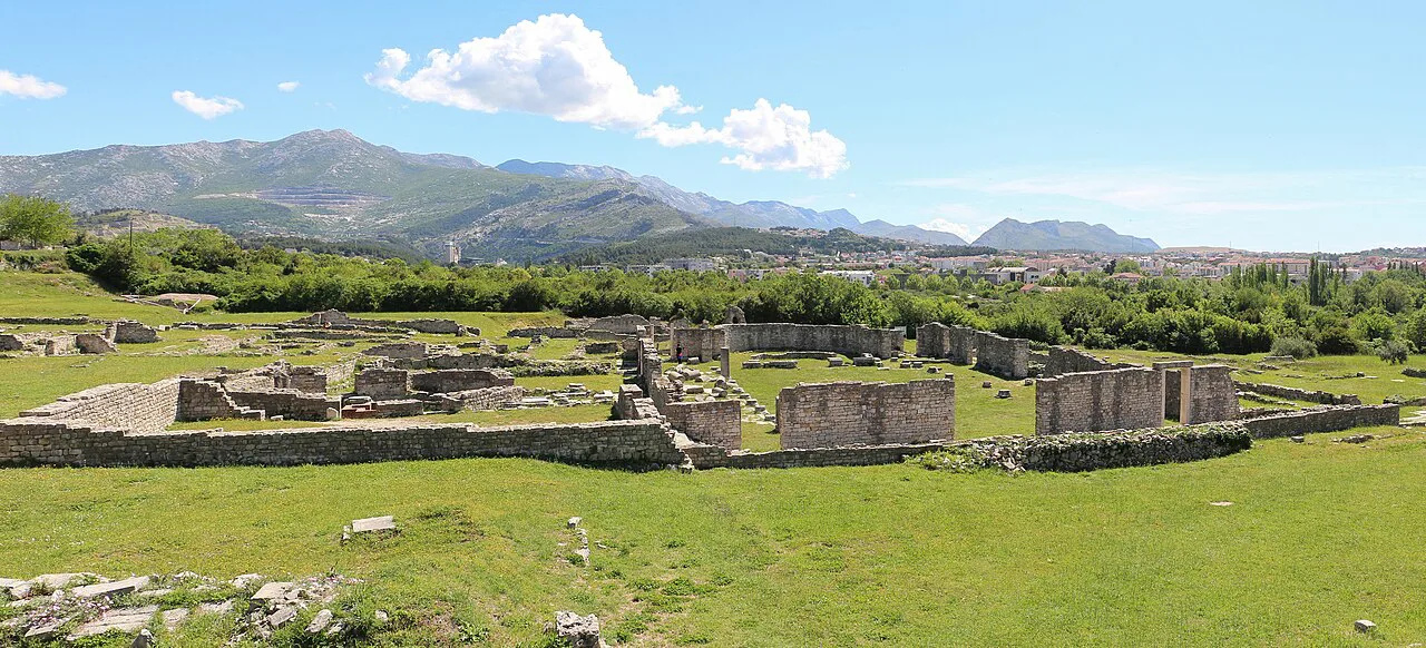 Ruins of the Episcopal Centre at ancient Salona, with mountains behind.