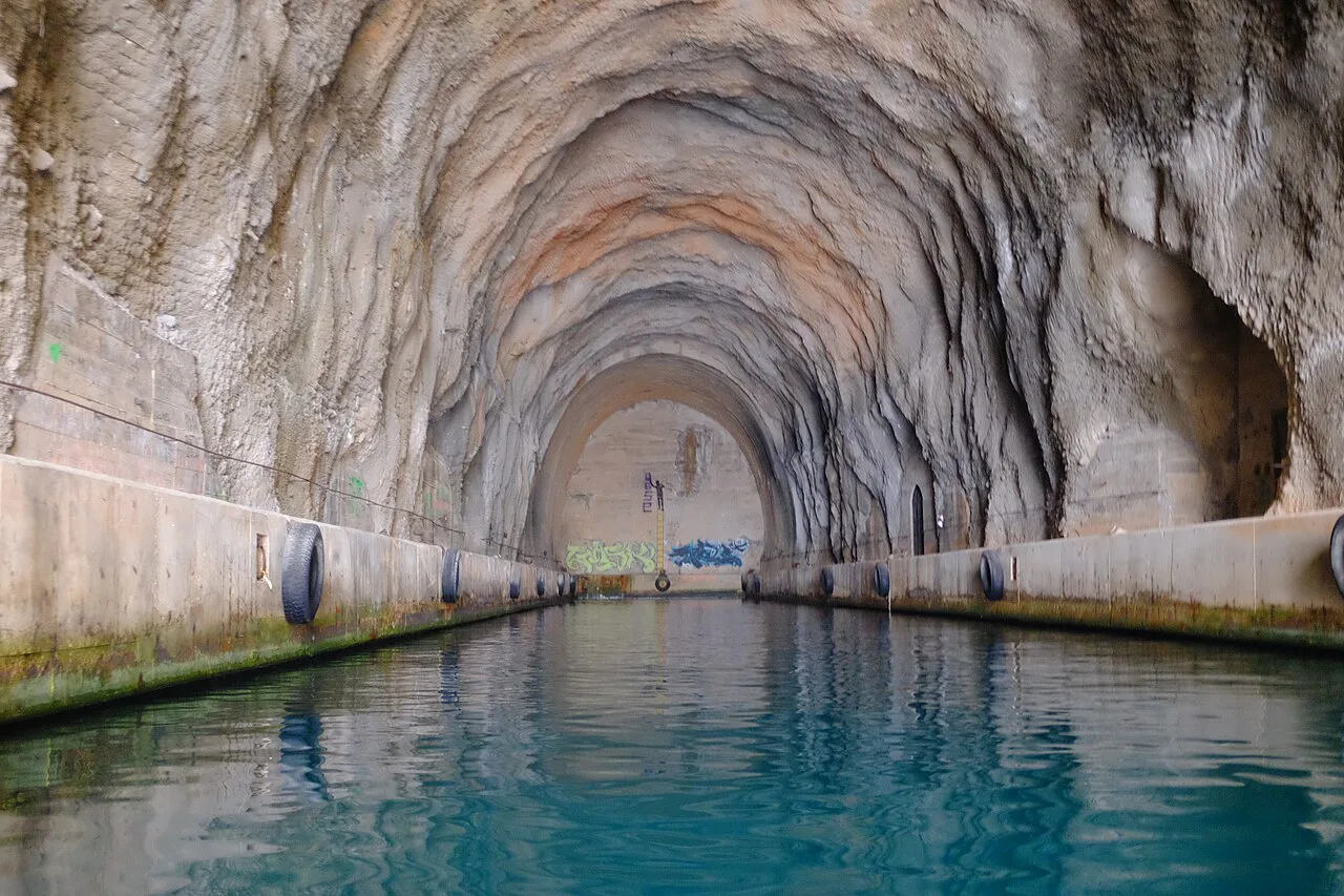Water running through a long tunnel cut into the rock on Dugi Otok, Zadar