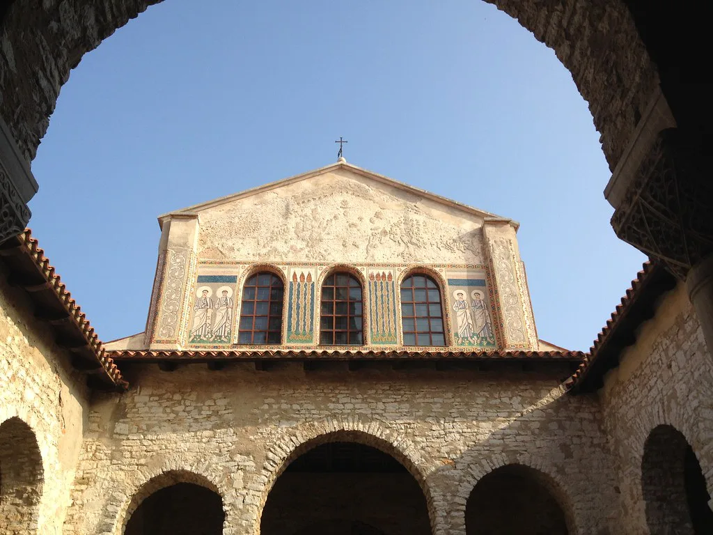 The Euphrasian Basilica in Poreč seen through an arch of the courtyard