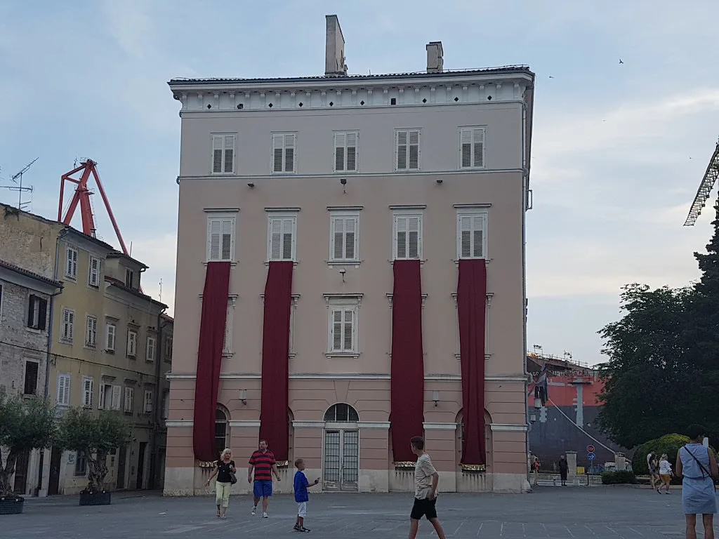 A pink-fronted building on the Forum square in Pula