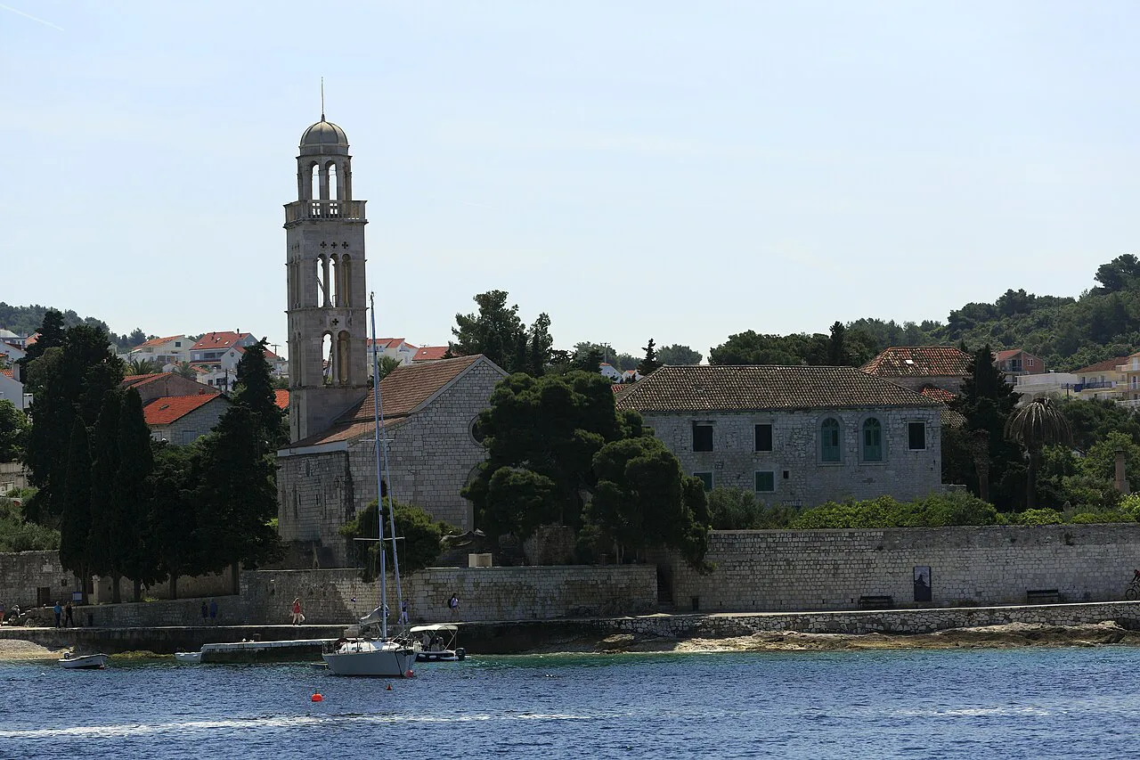 The Franciscan monastery and its bell tower by the water at the edge of Hvar Town.