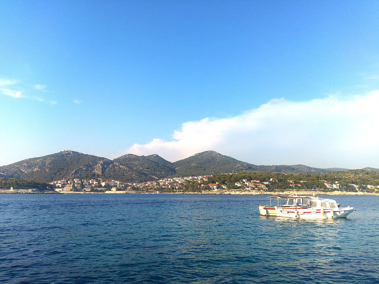 View of Hvar from the Adriatic Sea with a boat in the foreground