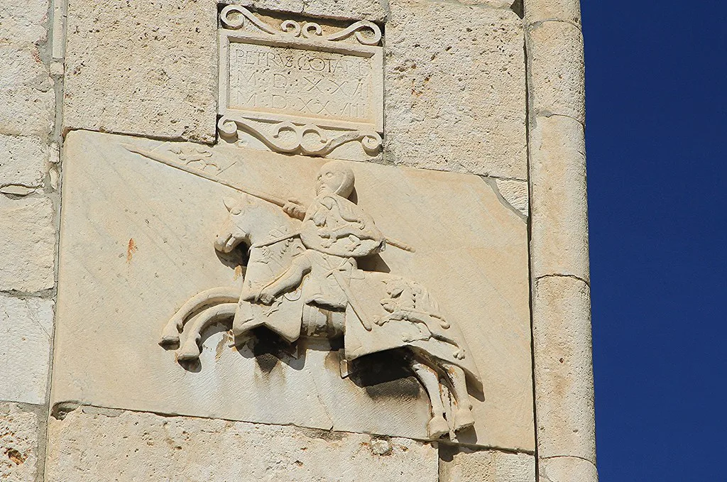A carved stone relief of a knight on the exterior of Pula's Town Hall, Pula