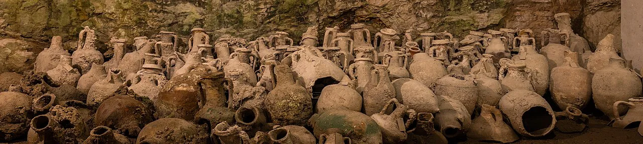 Rows of ancient amphorae displayed in the underground galleries of the Pula Arena