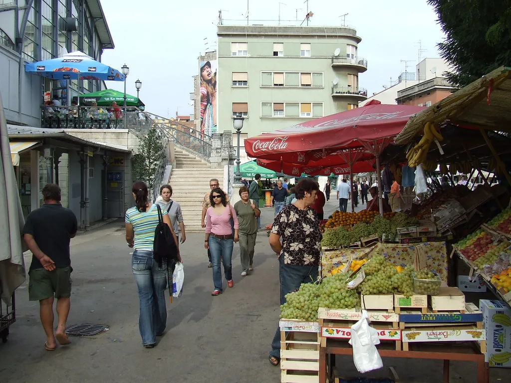 Shoppers browsing fruit and vegetable stalls at the farmers' market in Pula