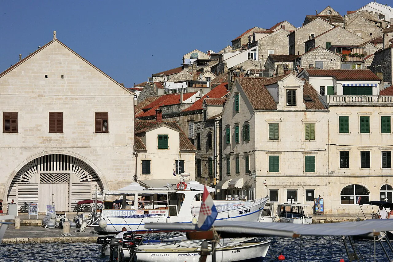 Boats in the port of Hvar Town in front of the Arsenal and stone houses