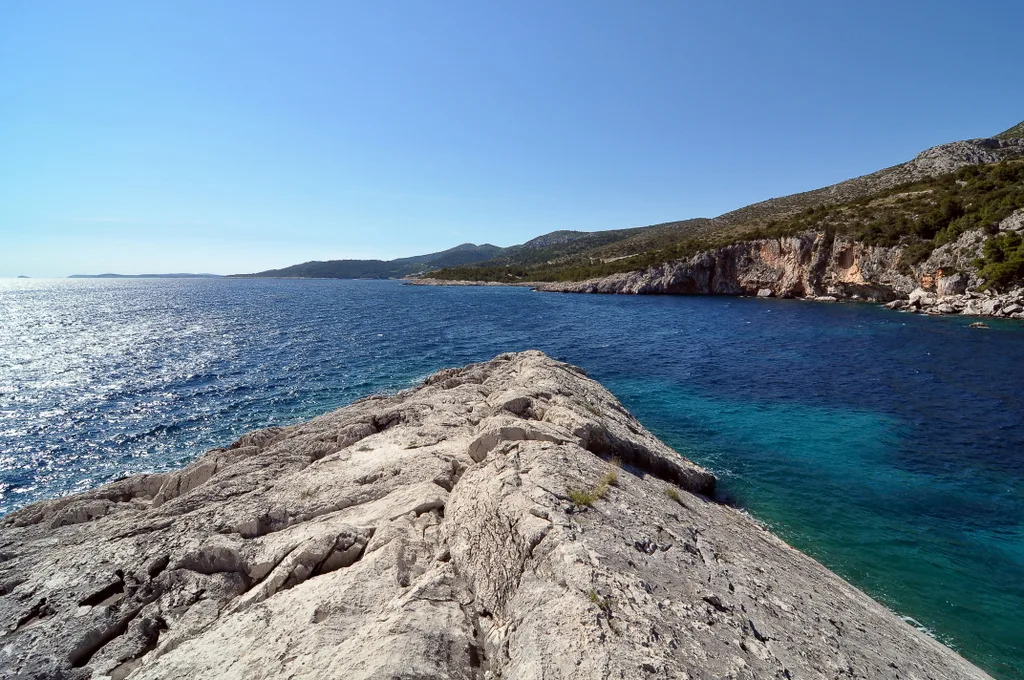 Rocky shoreline and clear blue sea on the coast of Hvar