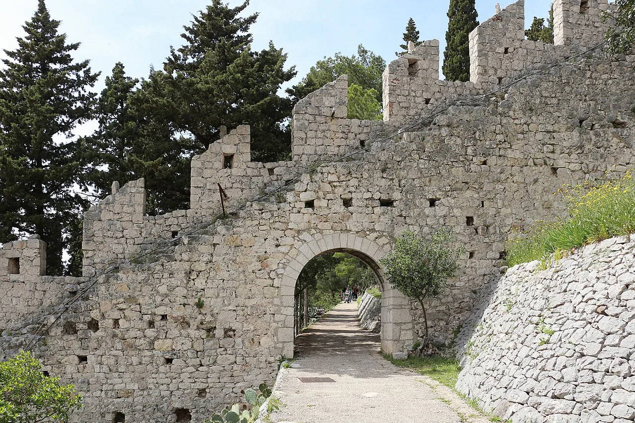 A stone gateway in the crenellated city walls of Hvar Town.