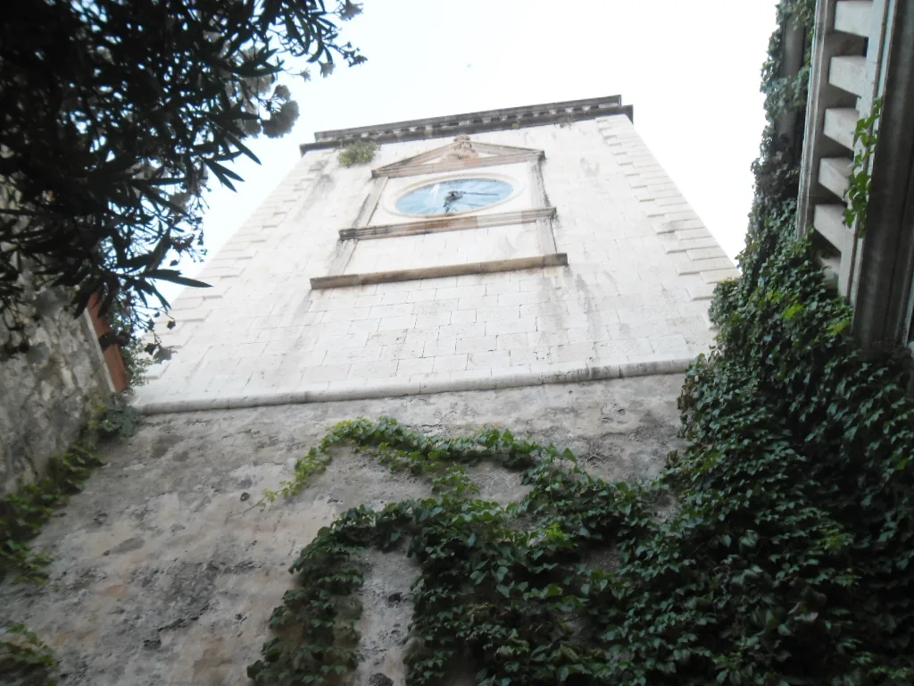 Looking up at the stone clock tower in Hvar Town