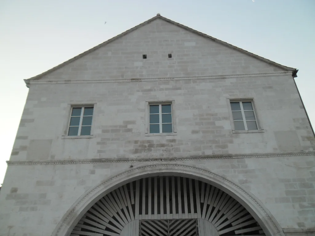 The stone façade and arched entrance of the Arsenal in Hvar Town.