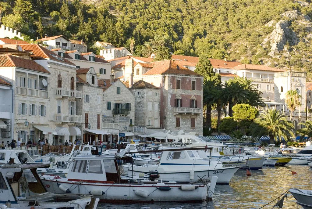 Boats moored in front of stone houses on the harbour in Hvar Town