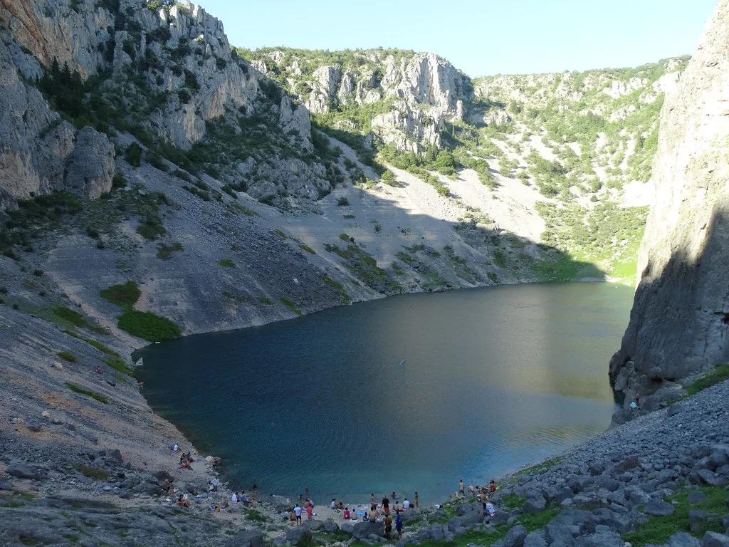 A lake at the bottom of a steep karst sinkhole near Imotski, Dalmatia