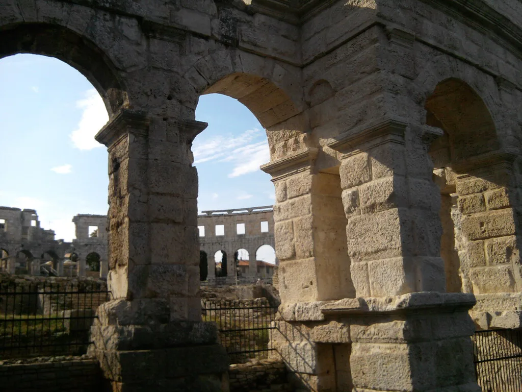 The Roman amphitheatre in Pula seen through one of its stone arches