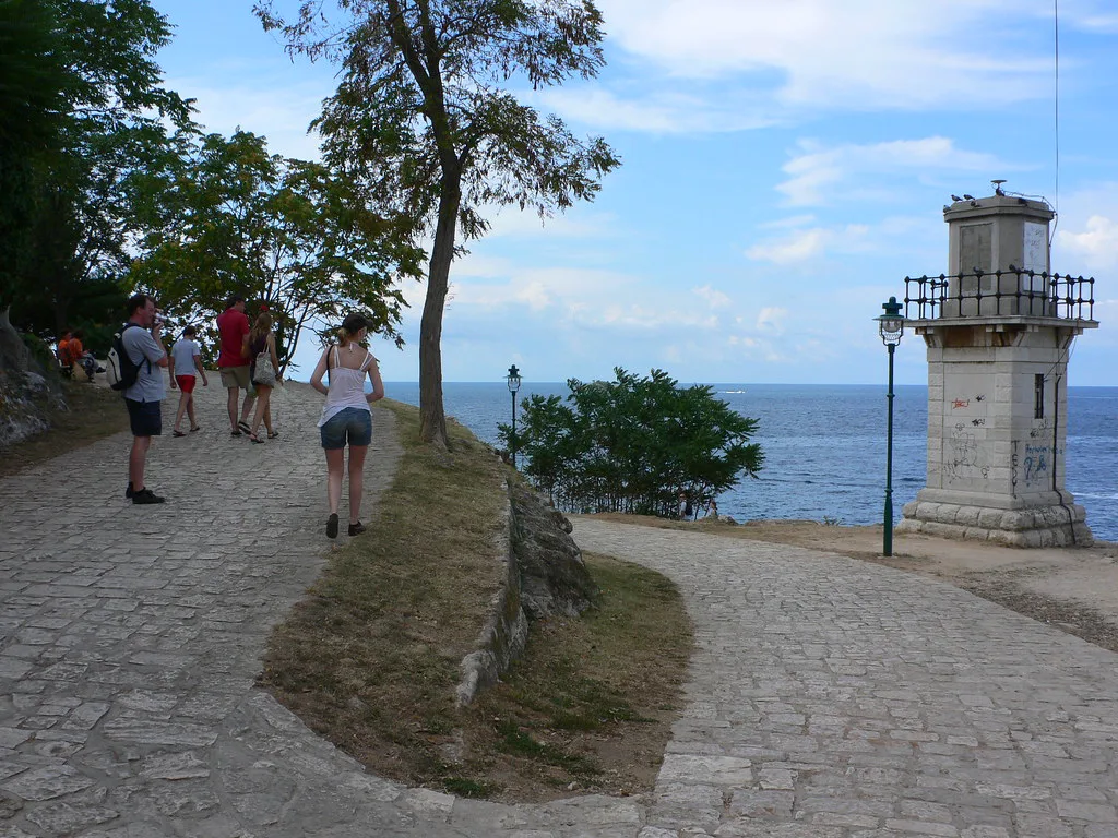 A coastal path leading to a small lighthouse on the edge of Rovinj