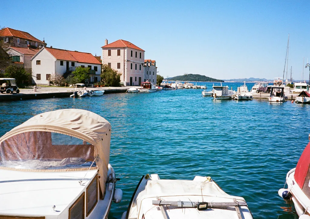 Small boats moored along the harbour on the island of Zlarin.
