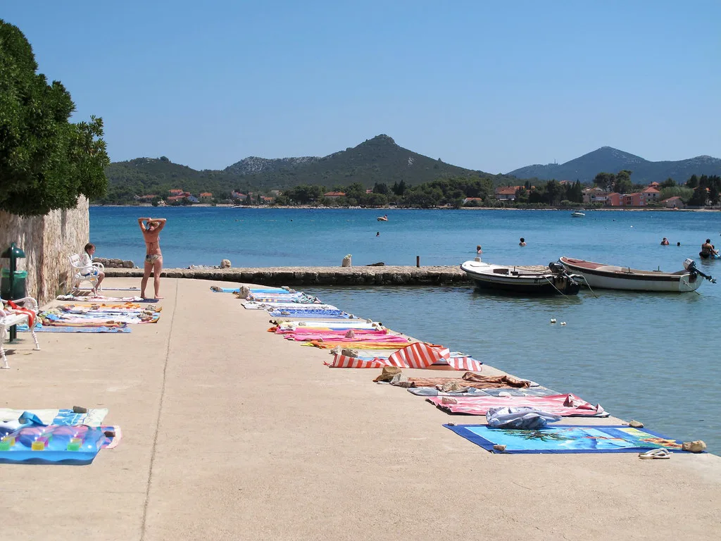 Towels laid out along a seaside promenade on the island of Ugljan, Zadar