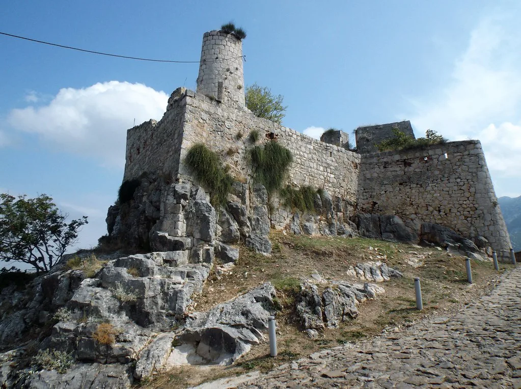Stone towers and walls of Klis Fortress on its rocky ridge, Dalmatia