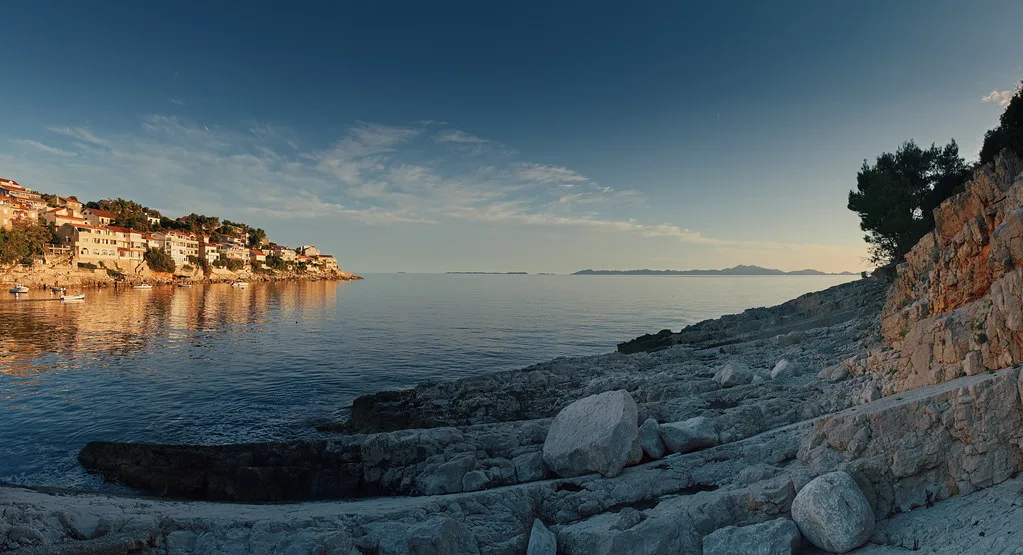Rocky shoreline and calm sea at Zavalatica on the island of Korčula.