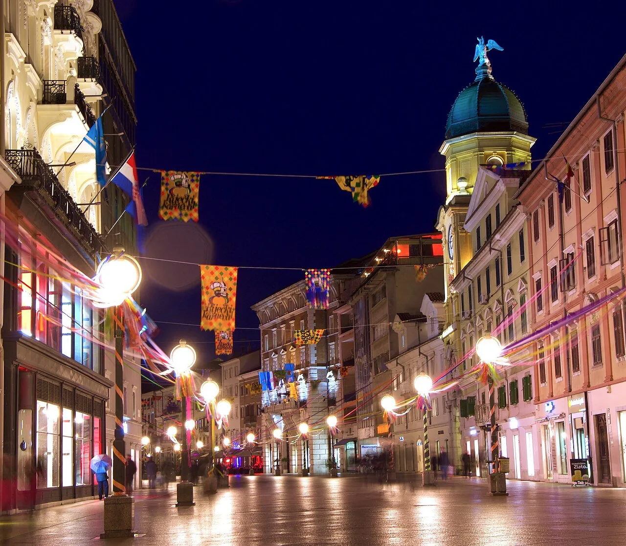 The Korzo promenade in Rijeka lit up by street lamps at night