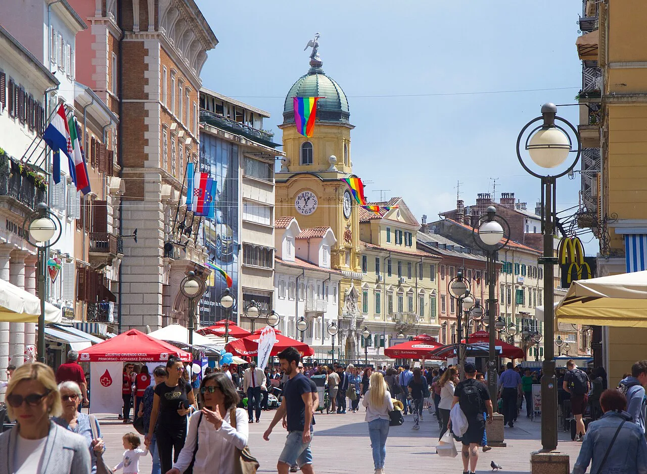 People walking along the Korzo towards the City Clock Tower in Rijeka