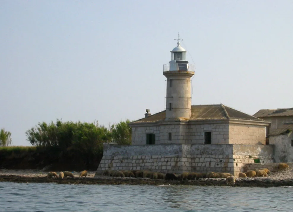 A stone lighthouse on the shore of the island of Lošinj, Kvarner
