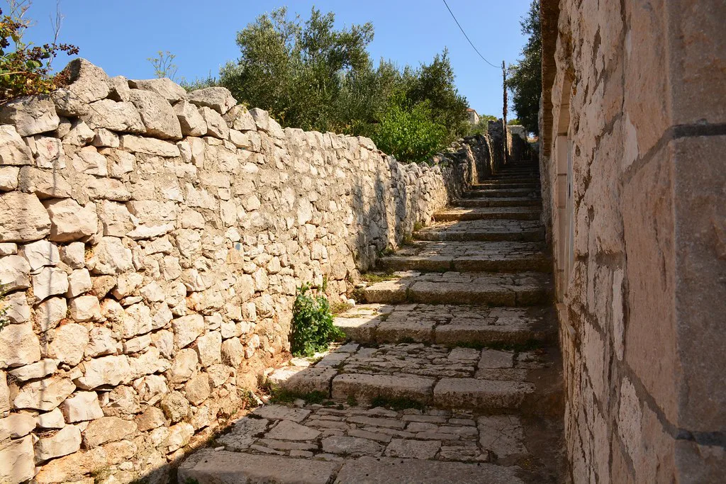 A narrow stepped lane between dry-stone walls in Lumbarda on Korčula.