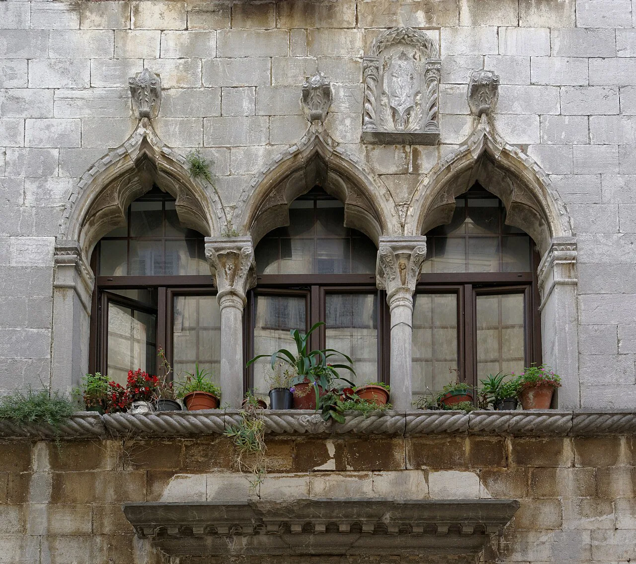 The Gothic House with its arched windows on the Decumanus in Poreč