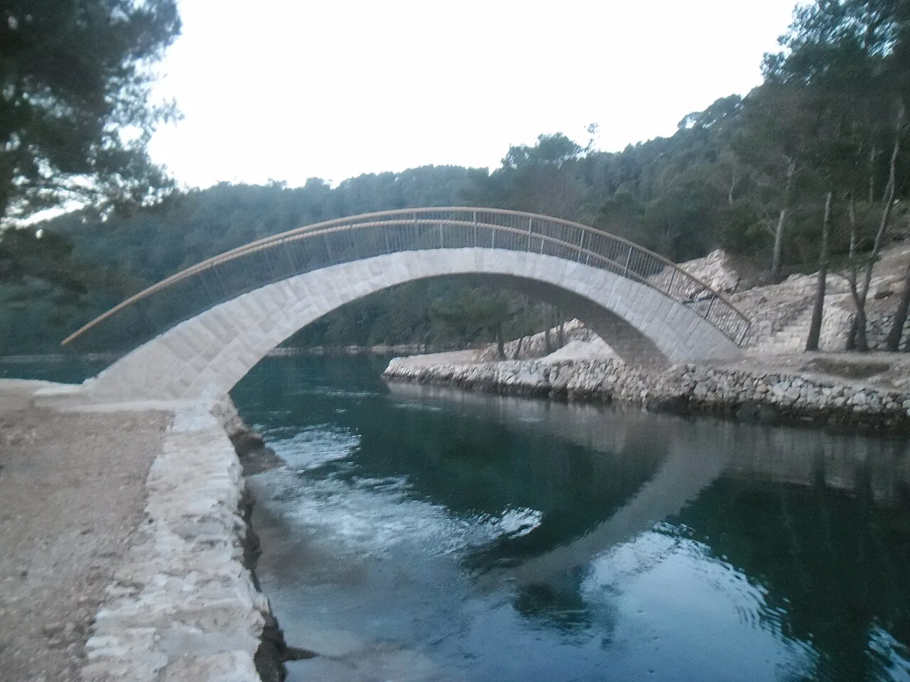 A white footbridge over a channel in Mljet National Park, Croatia