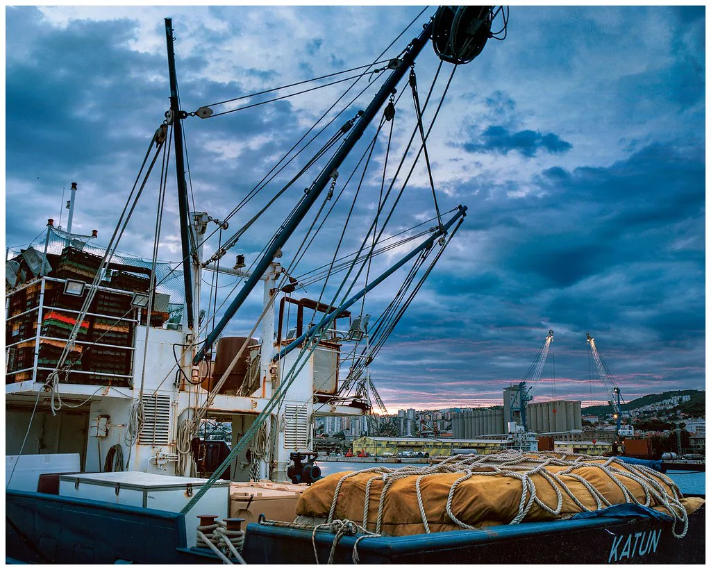 A fishing boat moored along the Molo Longo breakwater in Rijeka