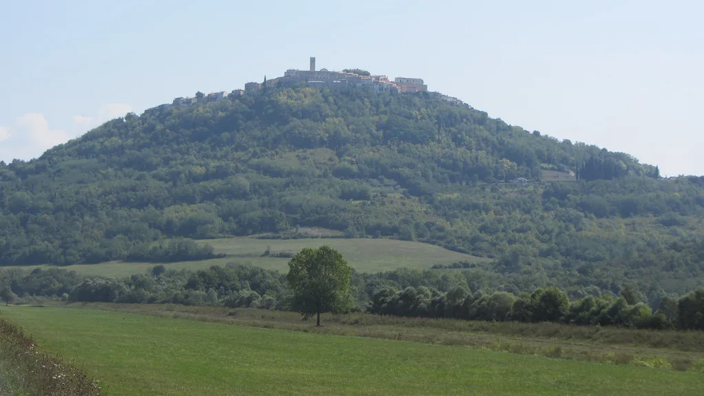 The hilltop town of Motovun rising above green fields in inland Istria